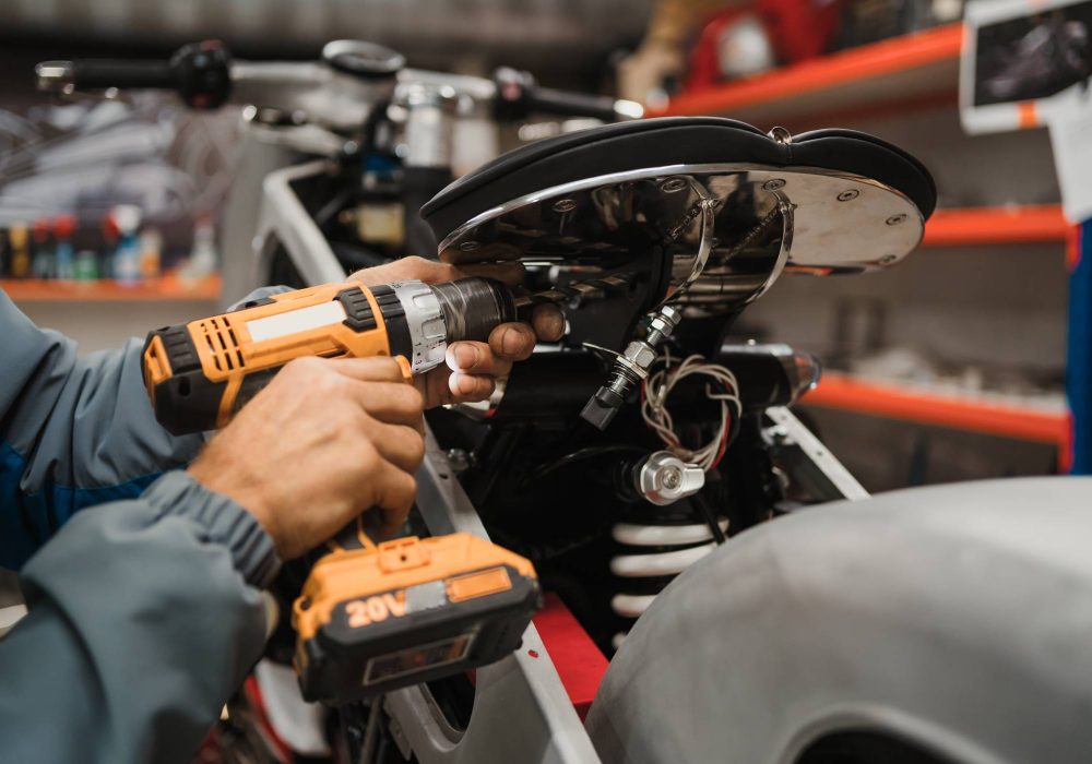 man-fixing-motorcycle-modern-workshop (1) man-fixing-motorcycle-modern-workshop (1)